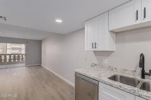 a kitchen with a sink and cabinets