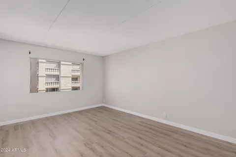a view of a room with wooden floor and window