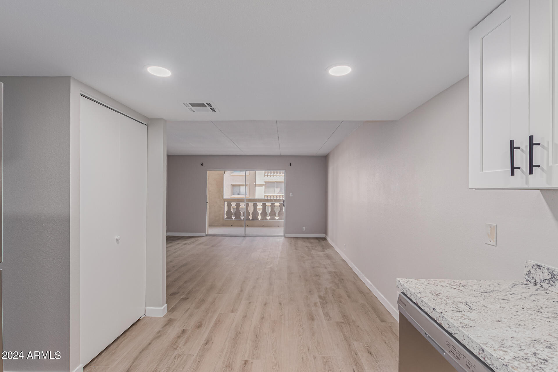 7930 East Camelback Road, Unit 506 Scottsdale, AZ 85251 - Photo 20 of 58 an empty room with wooden floor and windows