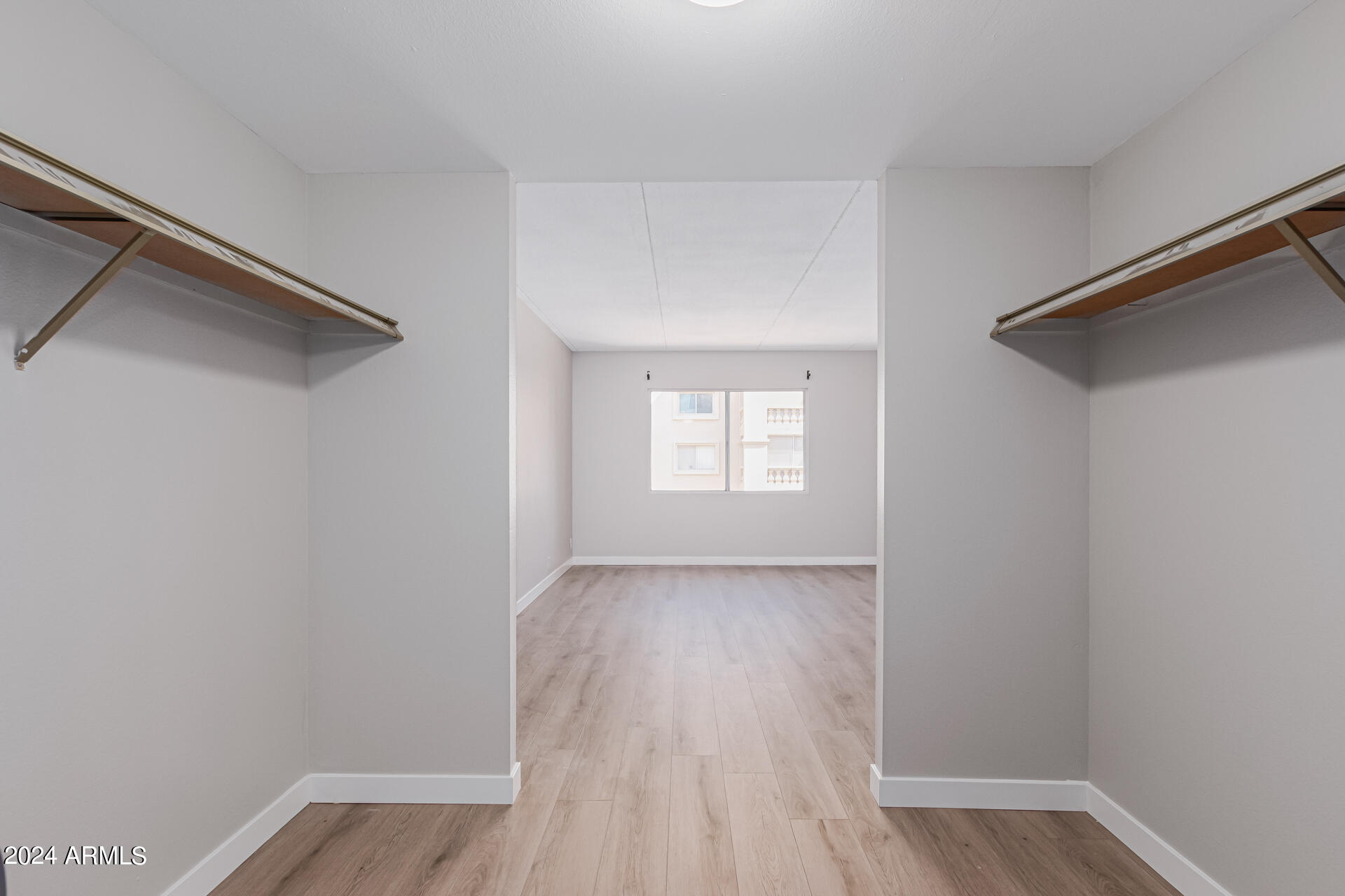 7930 East Camelback Road, Unit 506 Scottsdale, AZ 85251 - Photo 21 of 58 a view of an empty room with wooden floor and a window