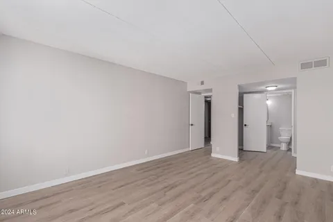 a view of an empty room and wooden floor