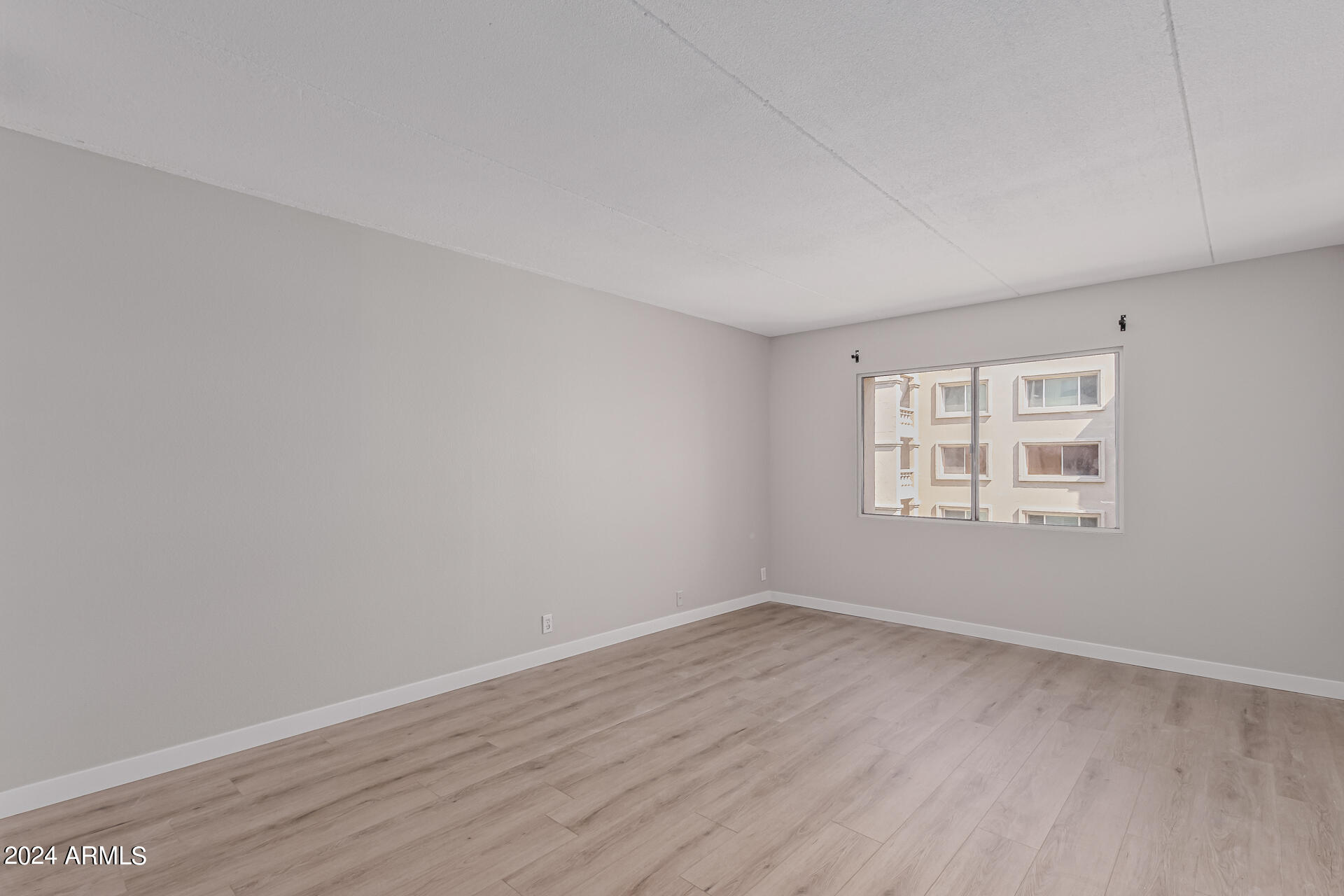 7930 East Camelback Road, Unit 506 Scottsdale, AZ 85251 - Photo 25 of 58 wooden floor in an empty room with a window