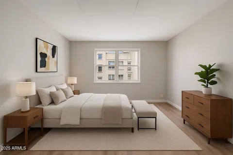 a bedroom with a large bed and a window
