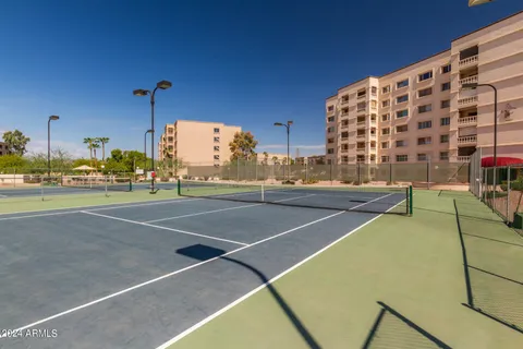 a living room with furniture and floor to ceiling window