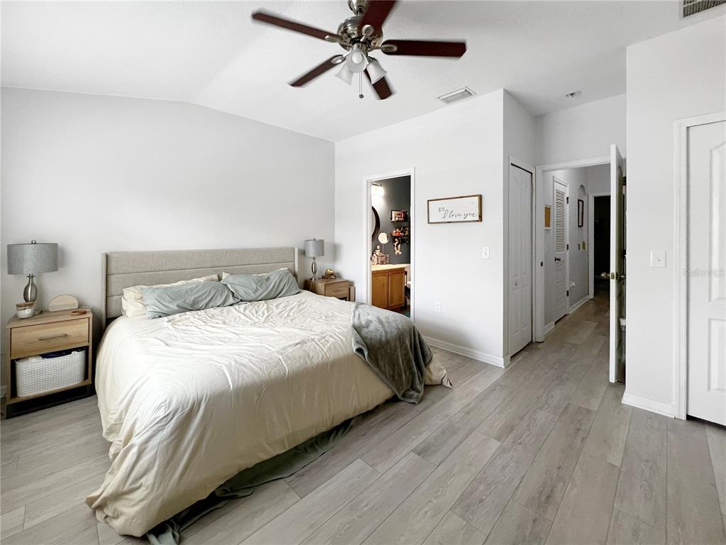 15767 Stable Run Drive Spring Hill, FL 34610 - Photo 22 of 34 a bedroom with a bed and wooden floor