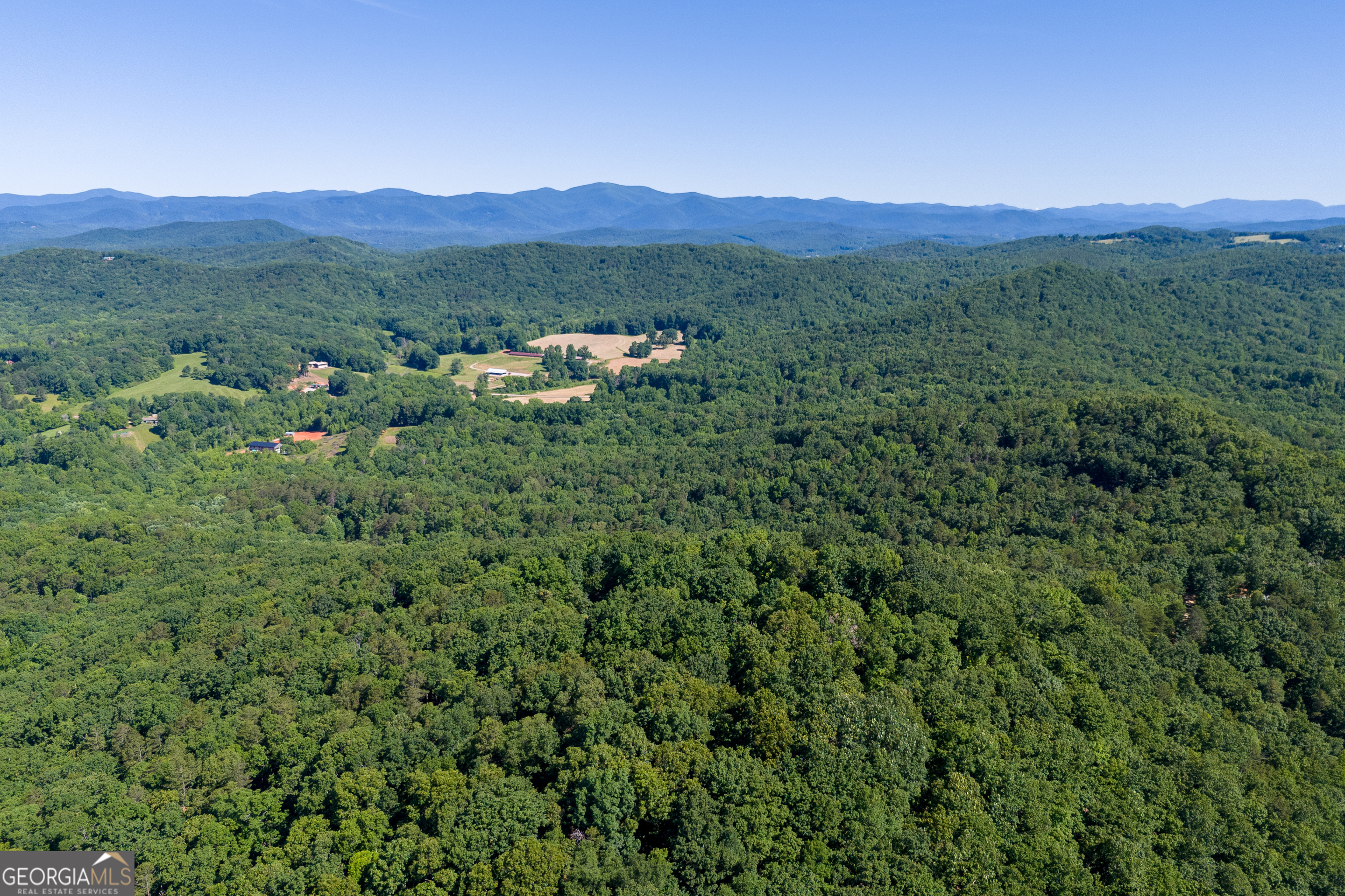 5012 Alec Mountain Road Clarkesville, GA 30523 - Photo 24 of 37 a view of a lush green hillside and a houses