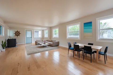 a view of a dining room with furniture and wooden floor