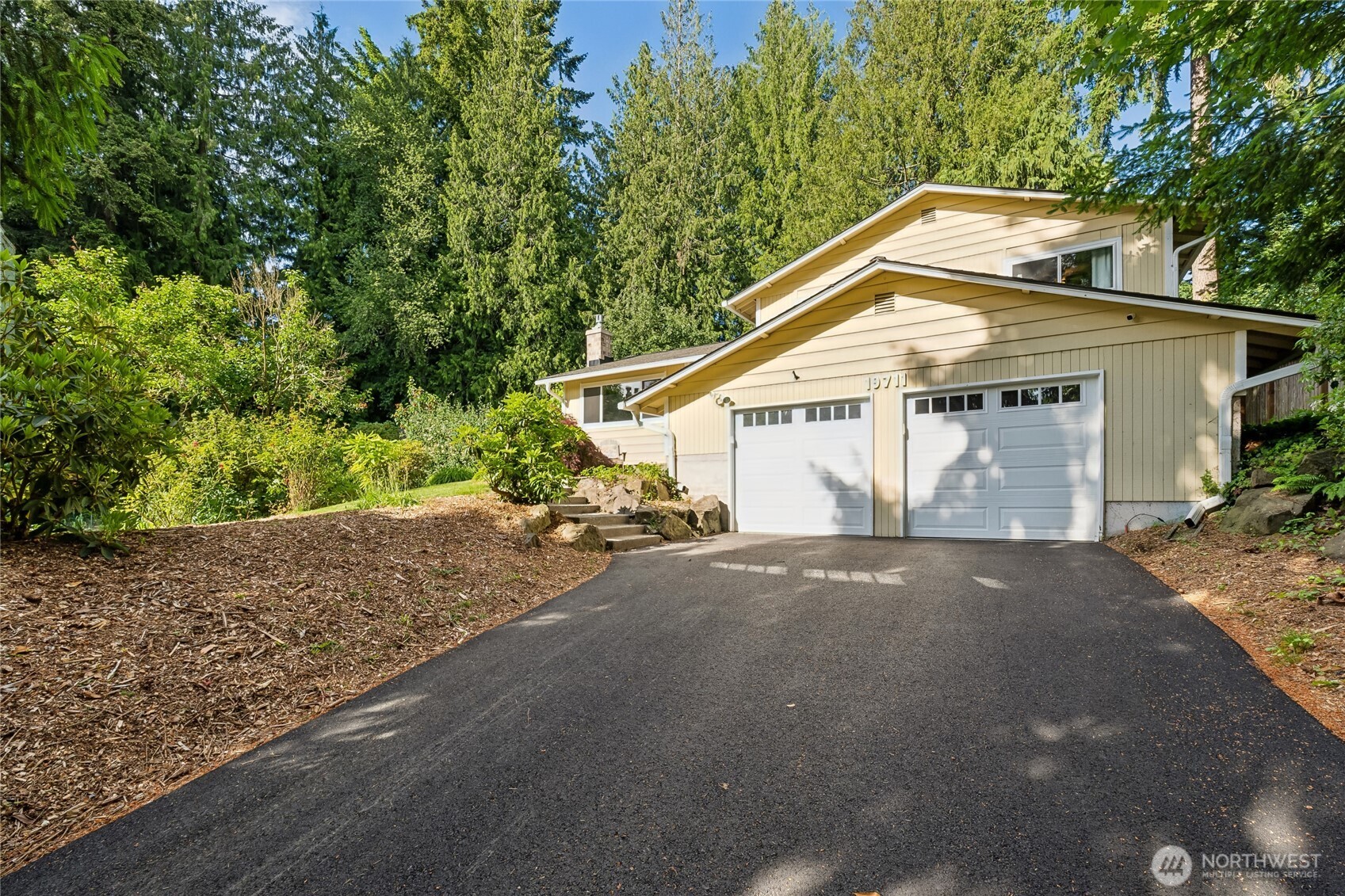 19711 34th Drive Southeast Bothell, WA 98012 - Photo 1 of 1 a front view of a house with a yard and garage
