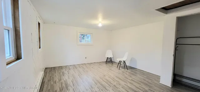 a view of room with window and wooden floor