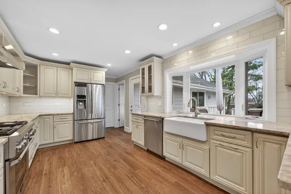 a kitchen with white cabinets and stainless steel appliances