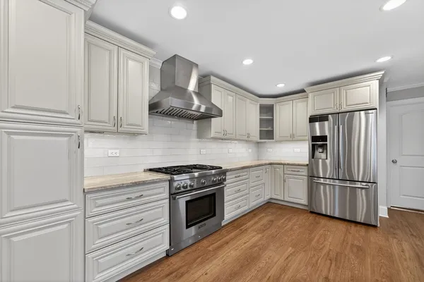 a kitchen with stainless steel appliances granite countertop a stove oven and refrigerator
