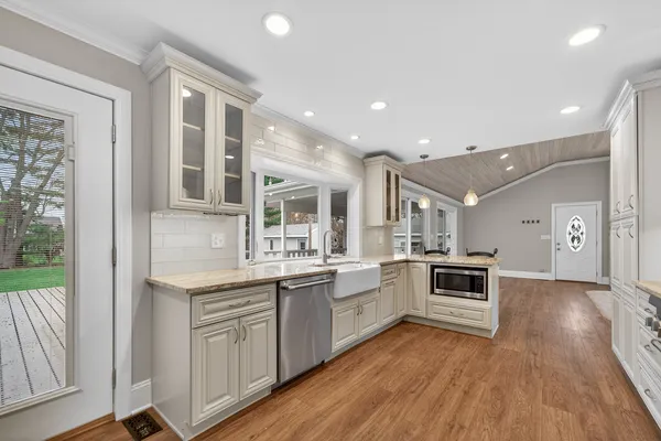 a kitchen with cabinets and wooden floor