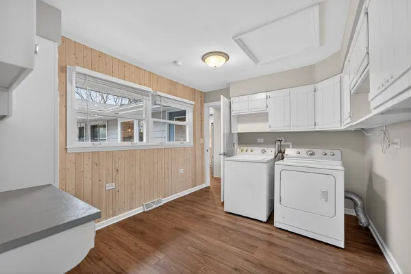 a view of a kitchen with stove and wooden floor
