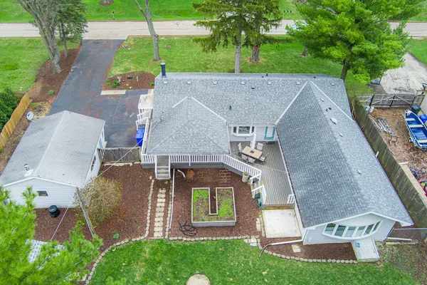 an aerial view of a house with a yard