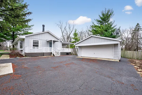 a view of a house with a yard and garage