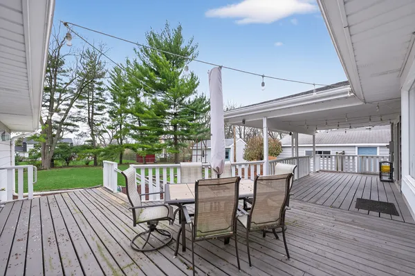 a view of a patio with a table and chairs