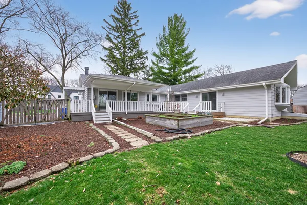 a view of a house with a yard and sitting area