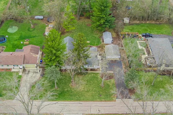 an aerial view of residential houses with outdoor space and parking
