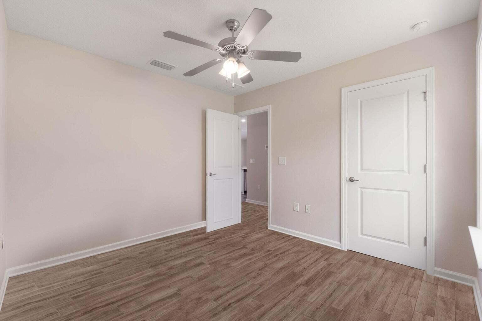 952 Mapoles Street Crestview, FL 32536 - Photo 21 of 32 a view of an empty room with wooden floor