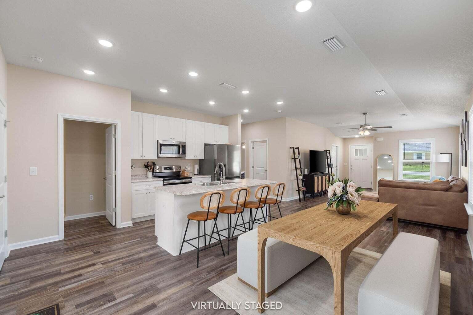 952 Mapoles Street Crestview, FL 32536 - Photo 10 of 32 a living room with stainless steel appliances kitchen island granite countertop furniture a couch and kitchen view