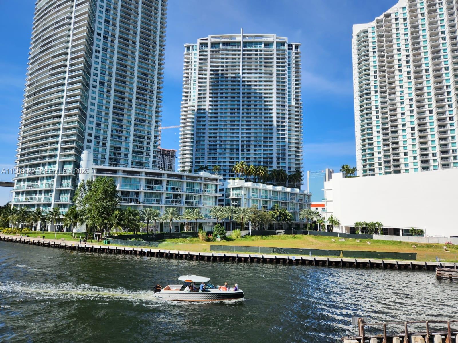 90 Southwest 3rd Street, Unit 3706 Miami, FL 33130 - Photo 3 of 21 a view of a lake with a building in the background