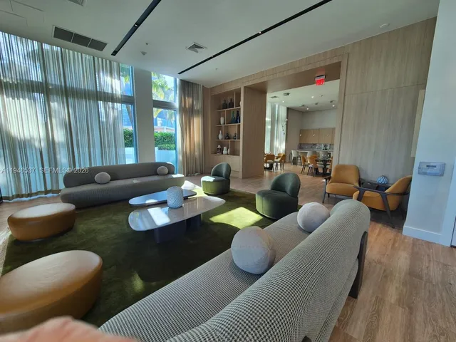 a large living room with furniture and a large window