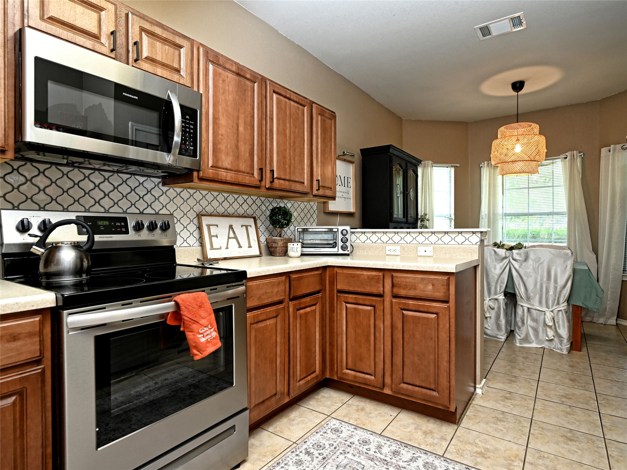 11401 Dimmitt Street Manor, TX 78653 - Photo 11 of 23 a kitchen with stainless steel appliances granite countertop a stove microwave and sink