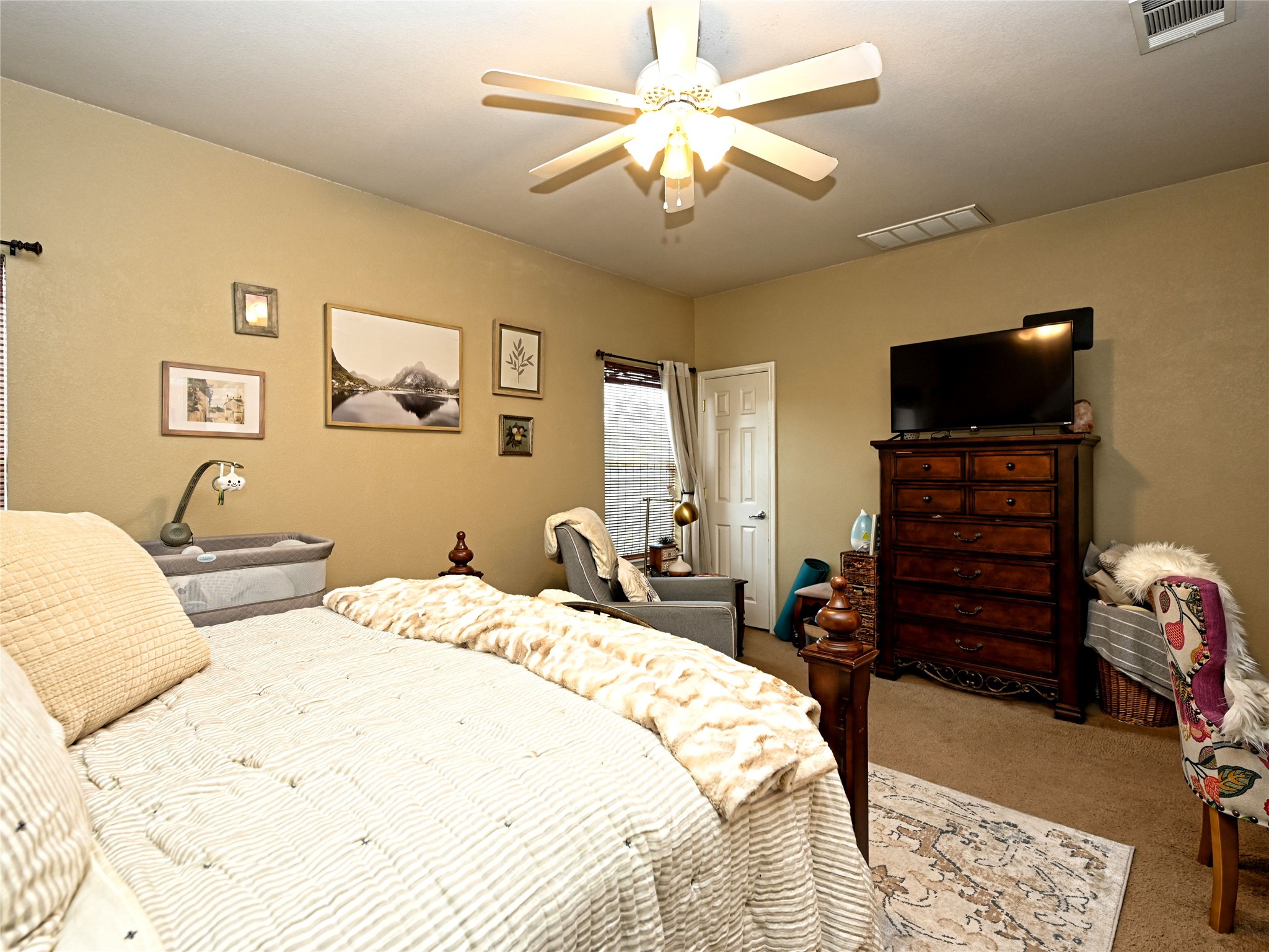 11401 Dimmitt Street Manor, TX 78653 - Photo 15 of 23 a bedroom with a bed and a chandelier