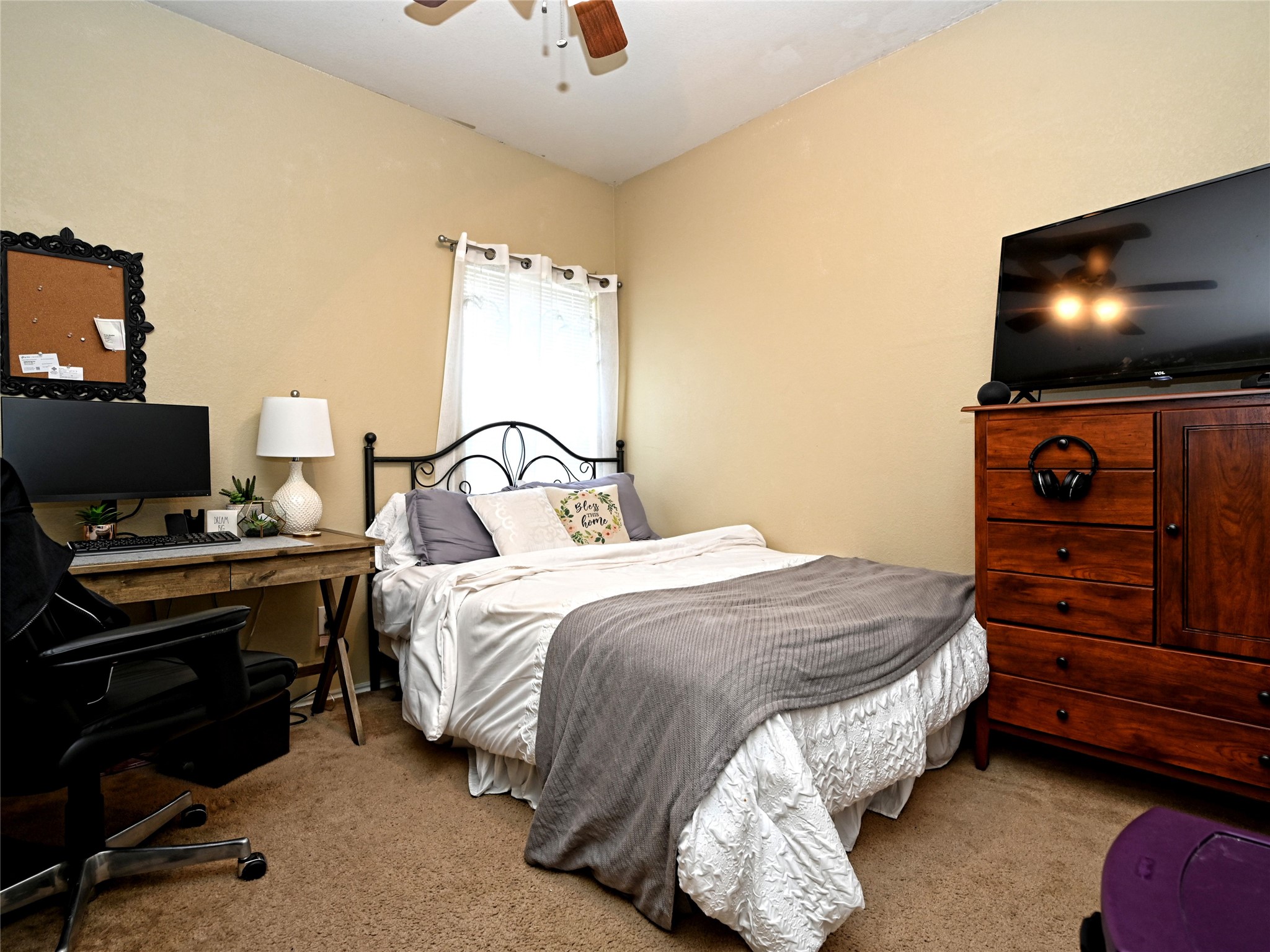 11401 Dimmitt Street Manor, TX 78653 - Photo 19 of 23 a bedroom with a bed and a flat screen tv