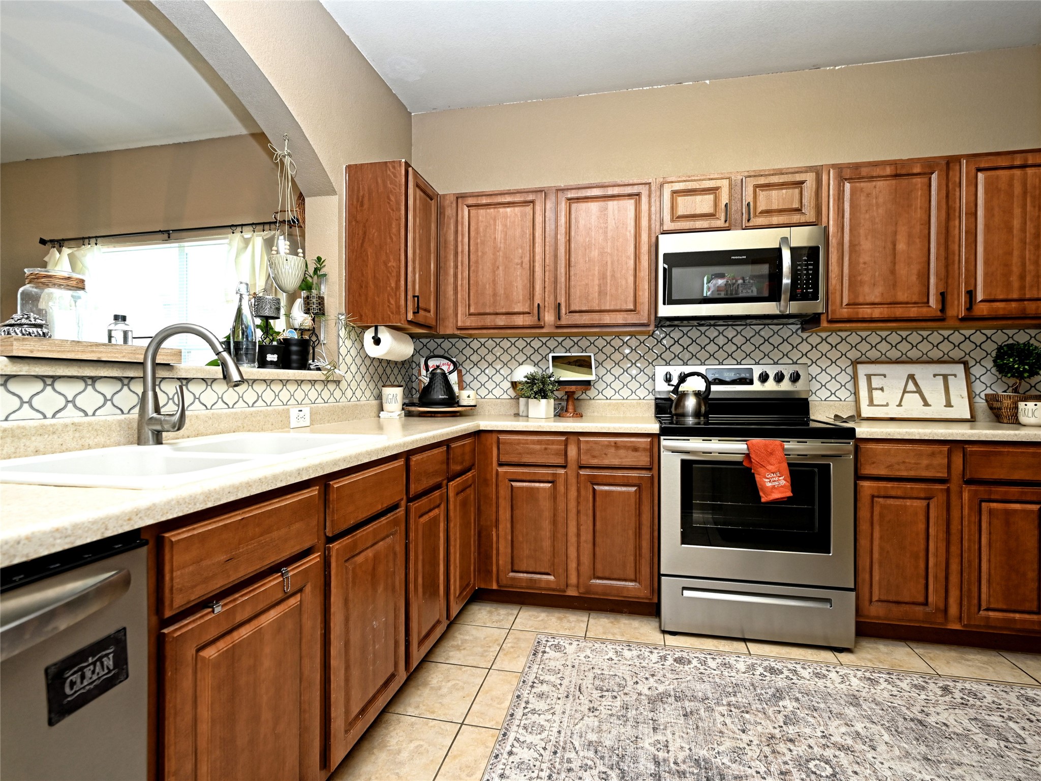 11401 Dimmitt Street Manor, TX 78653 - Photo 10 of 23 a kitchen with stainless steel appliances granite countertop a sink and cabinets