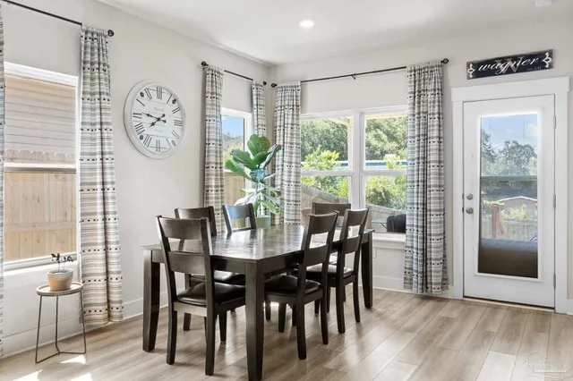 a view of a dining room with furniture window and wooden floor