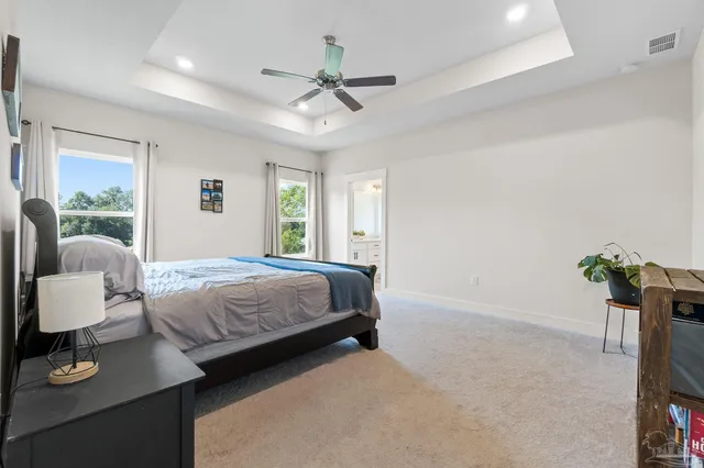 a bedroom with a bed potted plant with the outer view