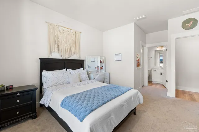 a bedroom with a bed and a night stand