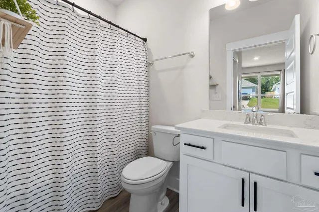 a bathroom with a sink a toilet and mirror