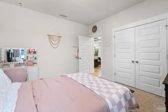 a bedroom with a bed and cabinets