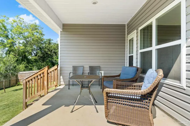 a view of balcony with wooden floor and outdoor seating