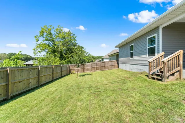 a view of a backyard with grass