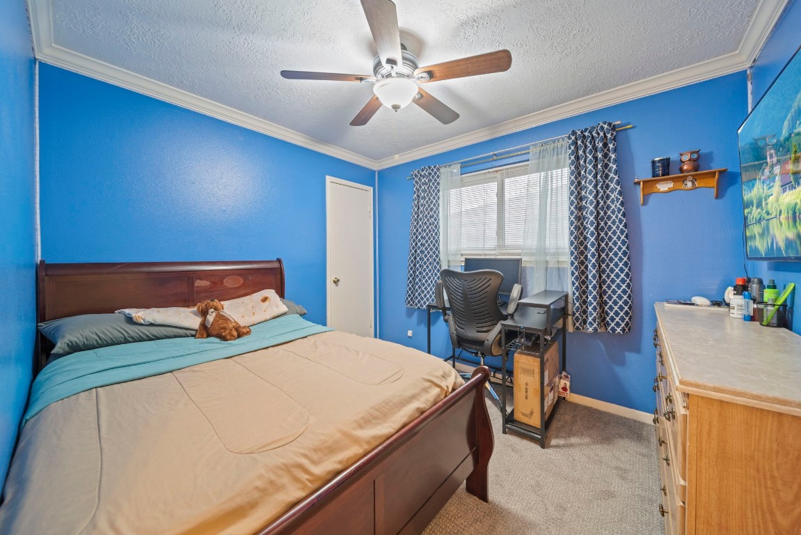 3805 Darling Street Pasadena, TX 77503 - Photo 12 of 23 a bedroom with a bed and a chandelier