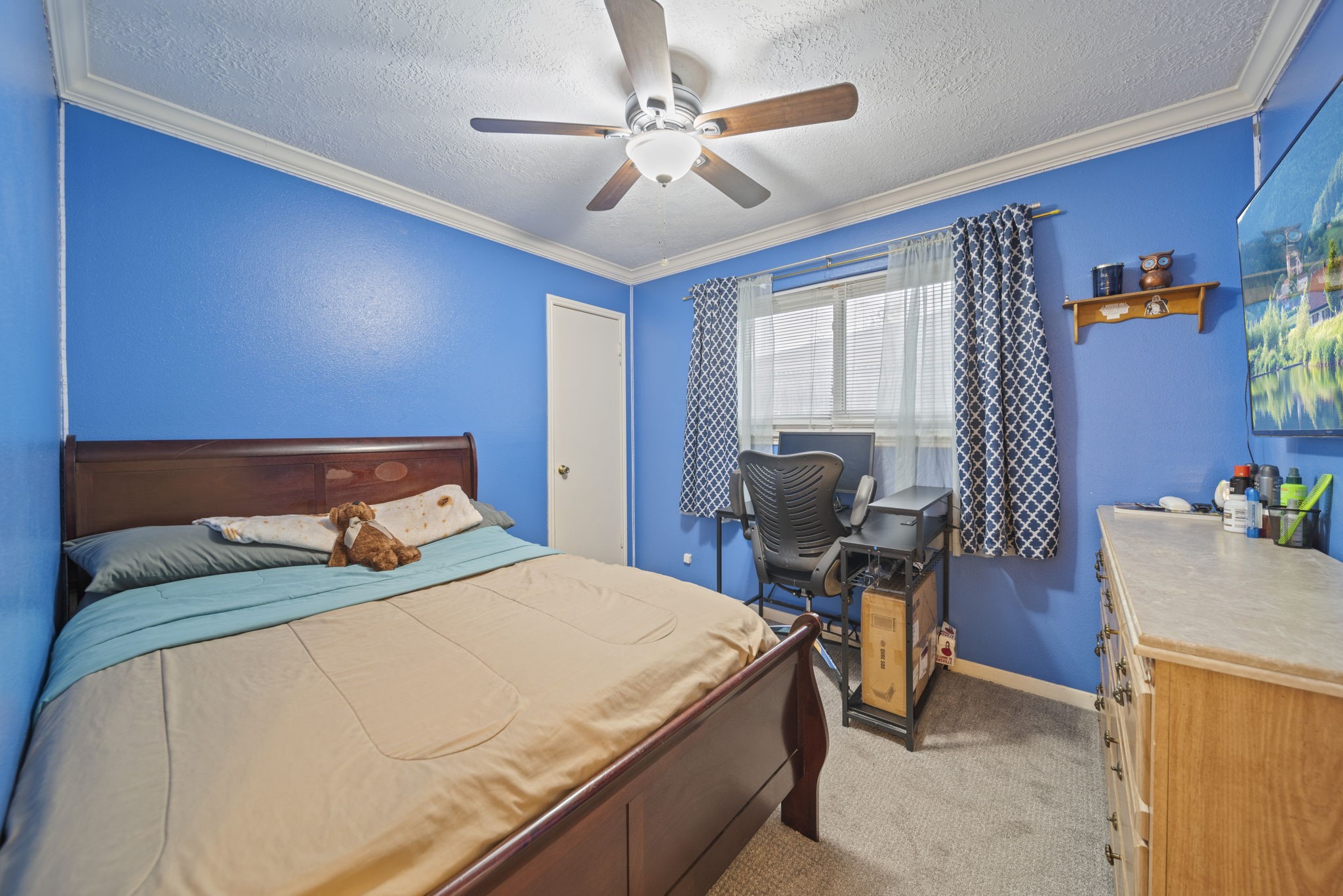 3805 Darling Street Pasadena, TX 77503 - Photo 12 of 23 a bedroom with a bed and a chandelier