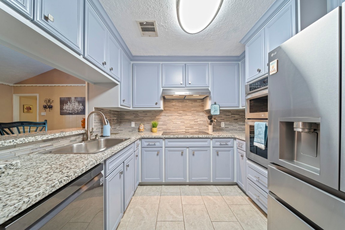 3805 Darling Street Pasadena, TX 77503 - Photo 6 of 23 a kitchen with granite countertop stainless steel appliances a sink stove and cabinets