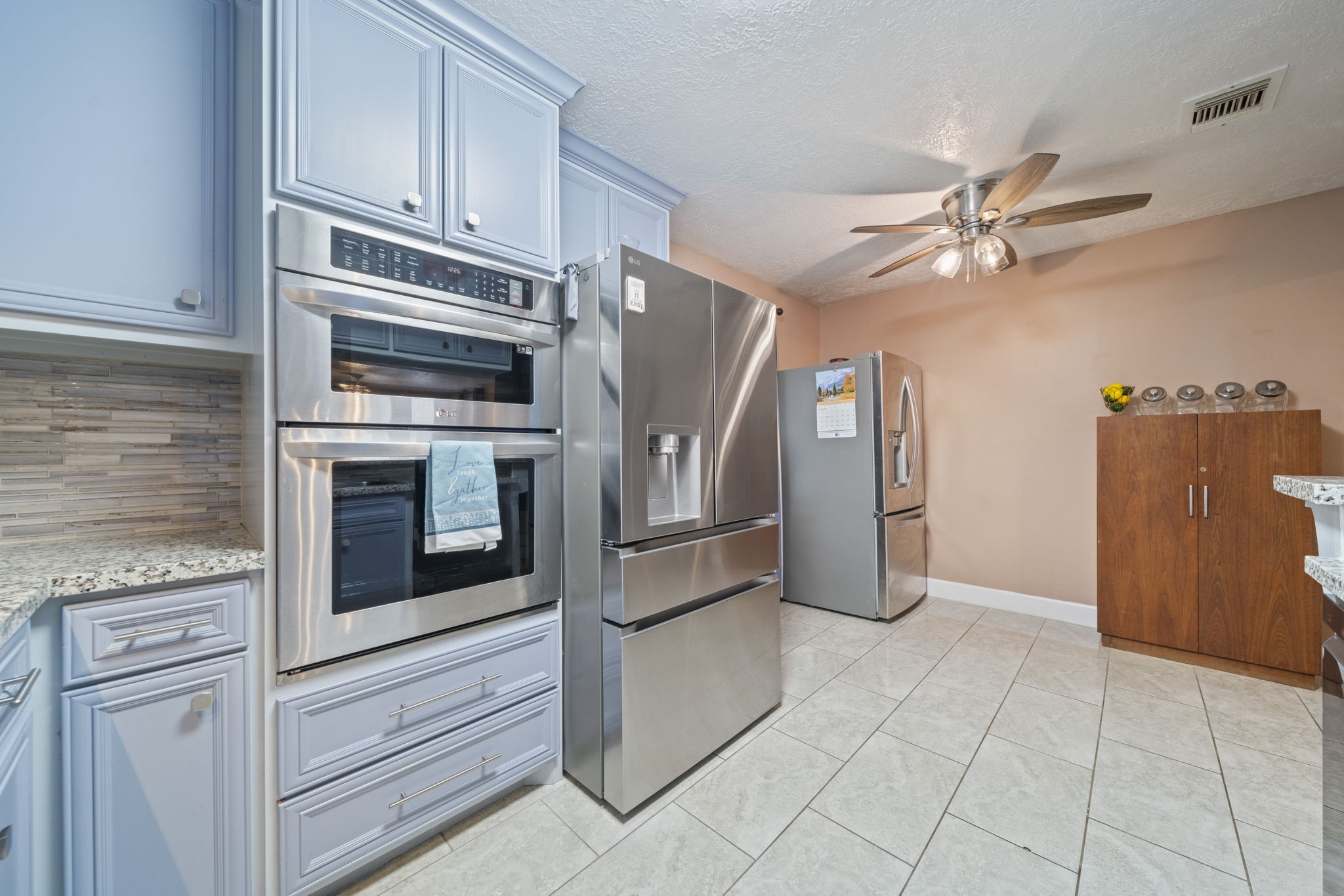 3805 Darling Street Pasadena, TX 77503 - Photo 7 of 23 a kitchen with granite countertop a refrigerator and a stove top oven
