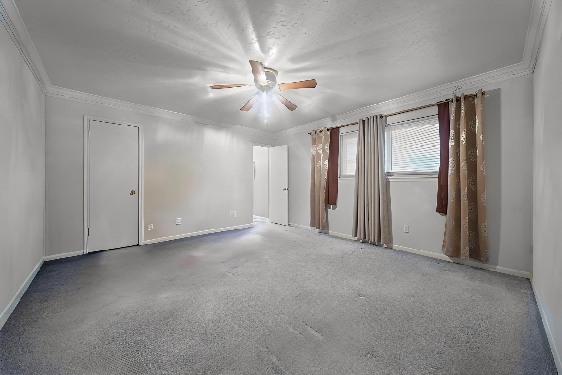 3805 Darling Street Pasadena, TX 77503 - Photo 9 of 23 an empty room with chandelier fan and windows