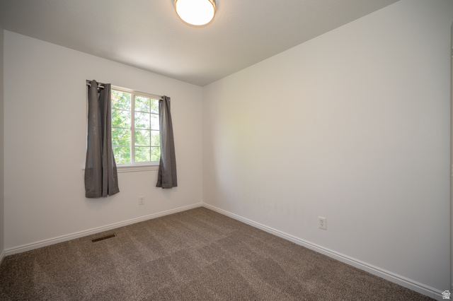 1799 West 1110th Street North Provo, UT 84604 - Photo 17 of 24 Neutral wall finishes with a single window featuring muntin bars and a flush-mount ceiling light
