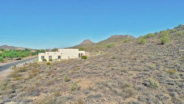 a view of a house with a mountain and yard