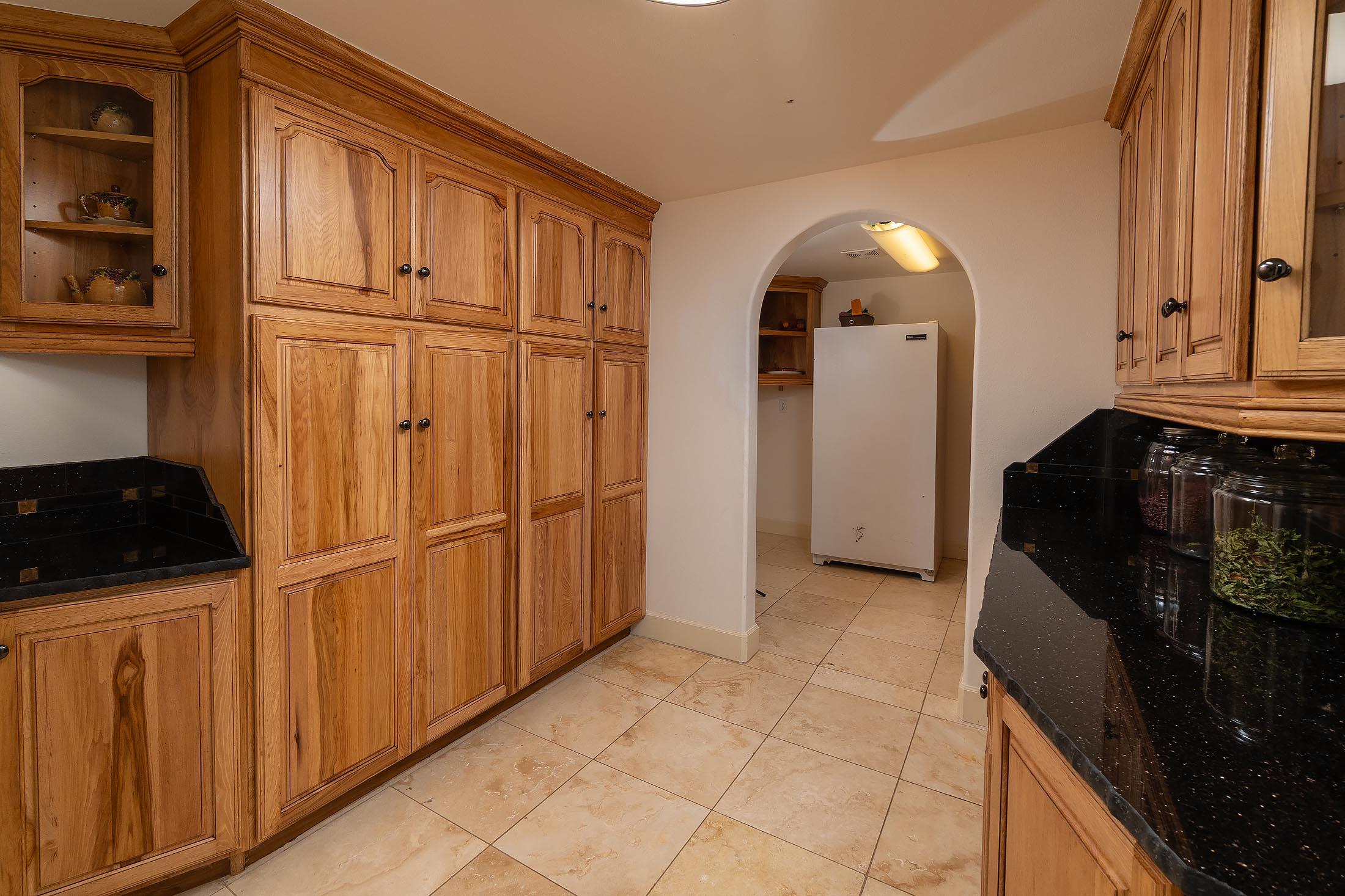 59047 Old Lake Road Christmas Valley, OR 97641 - Photo 34 of 55 Spacious pantry with granite counters and abundance of cabinets leading to freezer room
