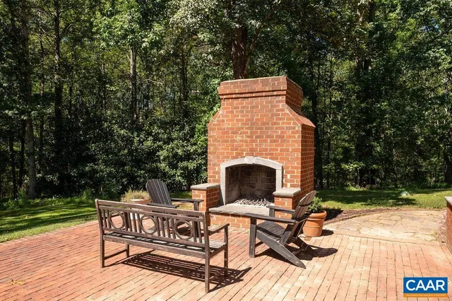 a view of a house with a yard and large tree