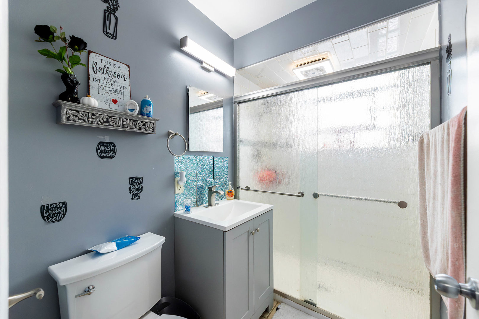 4147 Gage Avenue Lyons, IL 60534 - Photo 14 of 33 a bathroom with a sink mirror toilet and next to a window