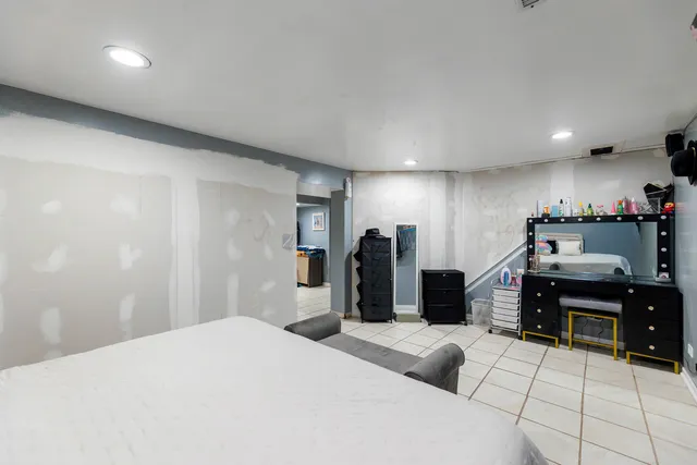 a bedroom with a bed and a desk