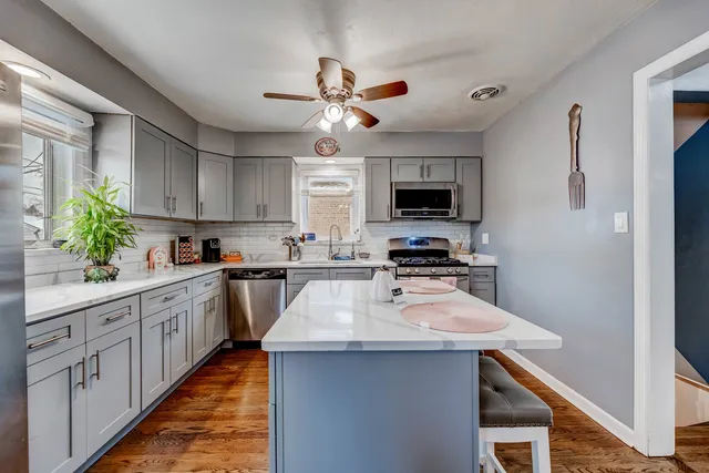 a kitchen with sink a microwave and cabinets