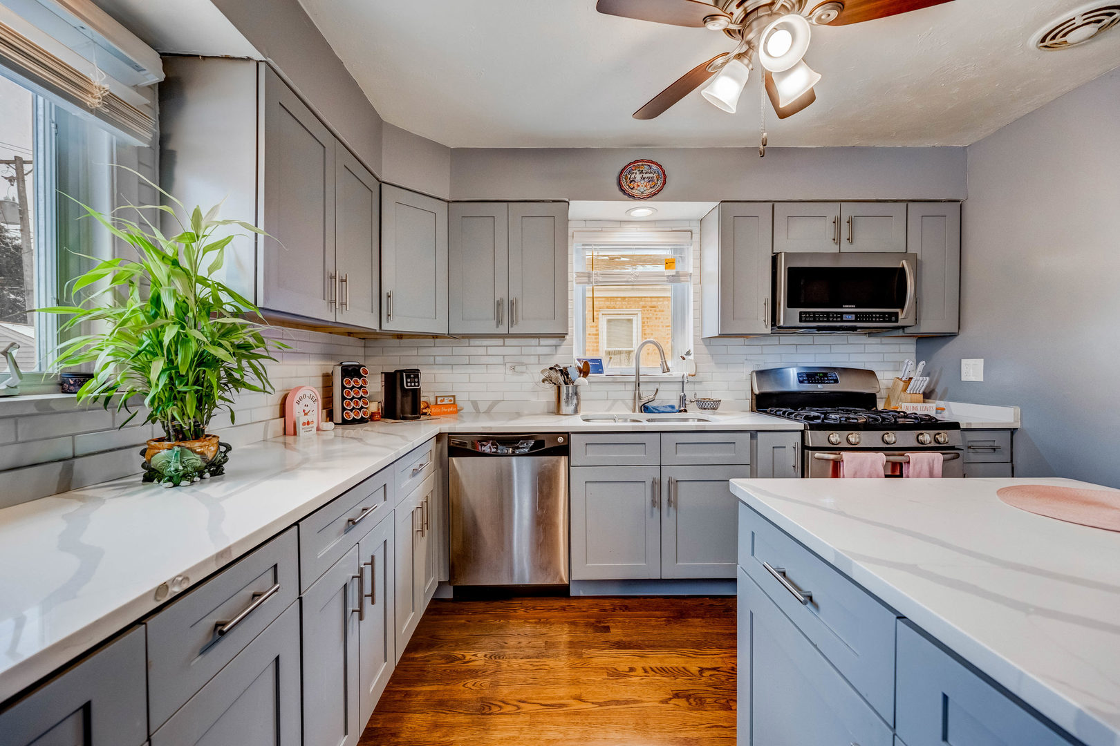 4147 Gage Avenue Lyons, IL 60534 - Photo 9 of 33 a kitchen with a sink a microwave a stove and cabinets